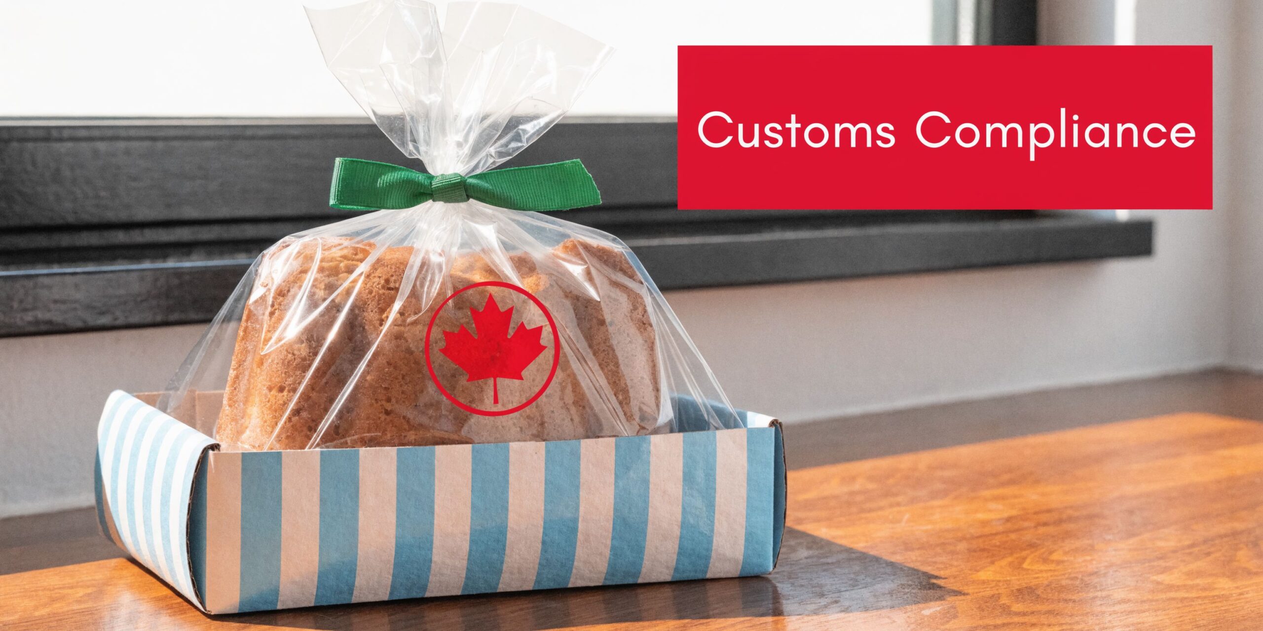 A bread loaf wrapped in clear plastic with a Canadian maple leaf logo in a blue striped box.