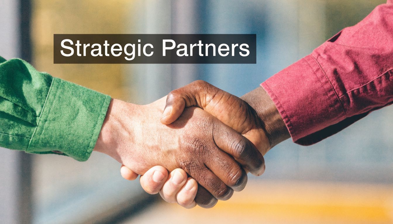 A close-up view of two business people shaking hands to symbolize a strategic partnership.