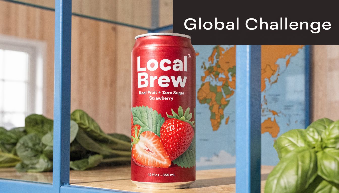 A can of Local Brew strawberry drink placed on a wooden shelf with a world map backdrop.